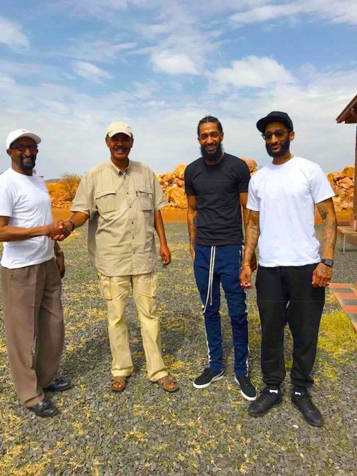 Nipsey Hussle and his family with Eritrean president Isaias Afwerki when they visited last year . Photo via @hadnetkeleta /Twitter.